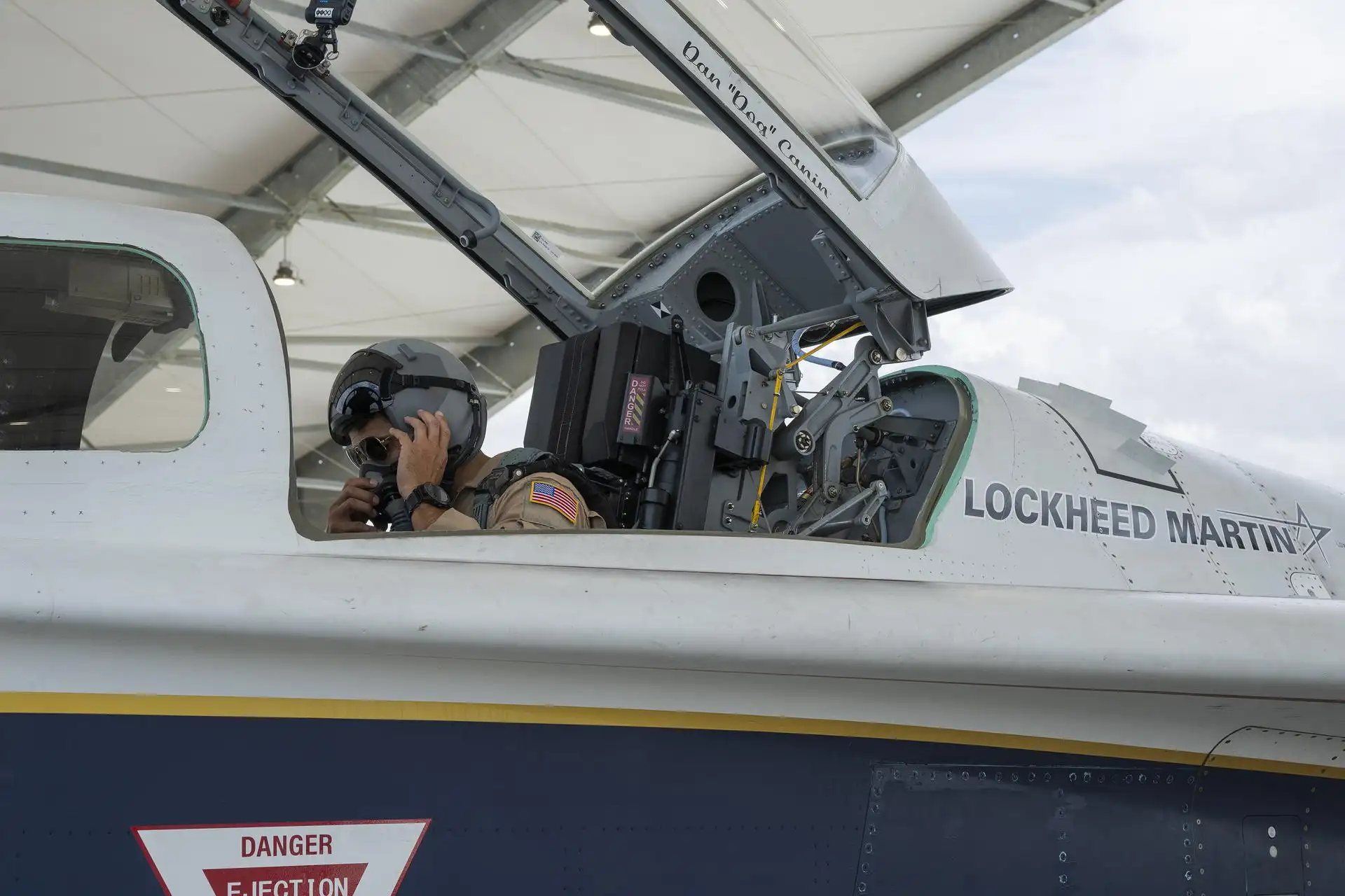 NASA pilot in the open cockpit of the X-59 aircraft during ground-test preparations